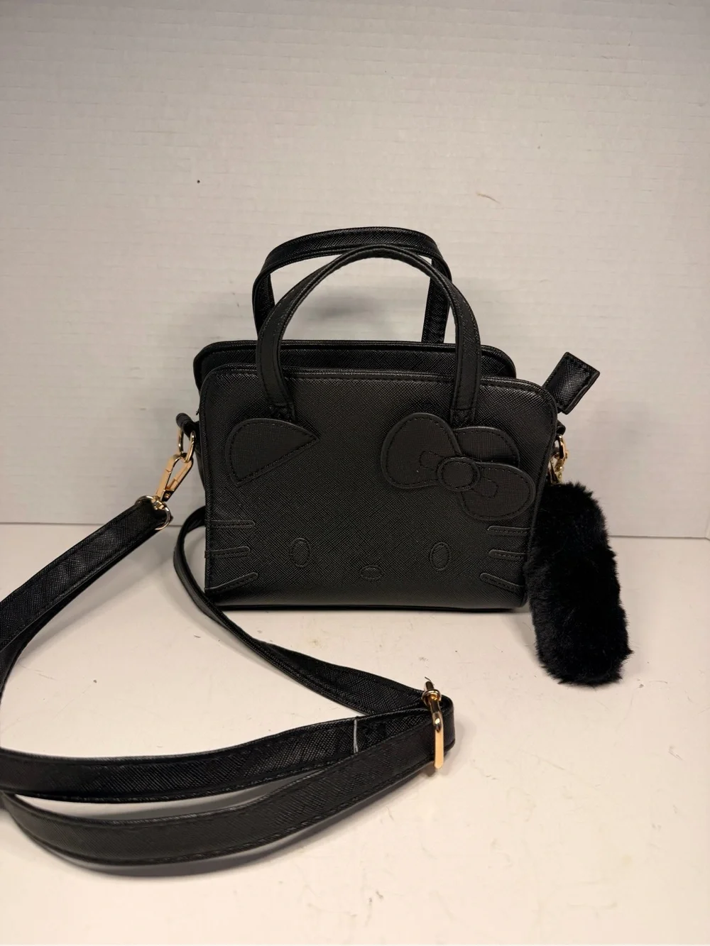 Sanrio Hello Kitty Black Faux Leather Crossbody Handbag with Pom Pom Charm